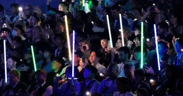 'Star Wars' fans wave lightsabers as an upcoming film gets announced in Japan
