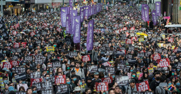 Thousands march as Hong Kong protests near half-year mark