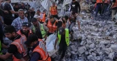 Building damaged in Israeli strikes collapses in Gaza, killing 21