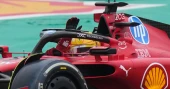 Lewis Hamilton waves to fans driving Ferrari F1