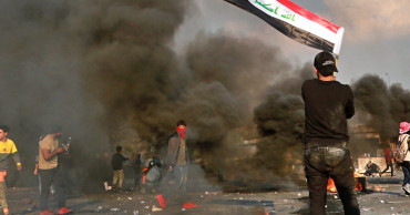Iraq officials: 1 dead as protesters take a Baghdad highway