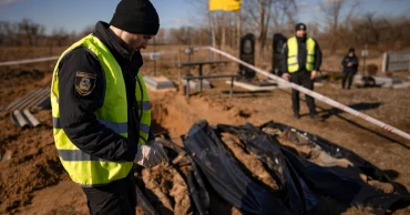 A year into Ukraine war, bodies dug up in once occupied town