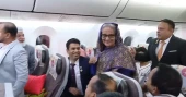 PM takes regular commercial flight on the way home from Geneva, exchanges pleasantries with passengers