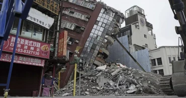 Earthquake aftershocks halt the demolition of a leaning building in Taiwan. Death toll rises to 13
