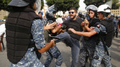 Lebanese police drag protesters, remove roadblocks in Beirut