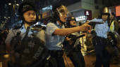 Hong Kong police draw guns, arrest 36 from latest protest